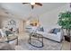Open-concept living area with ample seating and views into the kitchen and dining spaces at 15731 W Redfield Rd, Surprise, AZ 85379