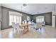 Elegant open-concept living and dining area with modern furniture, neutral tones, and tiled floors at 15731 W Redfield Rd, Surprise, AZ 85379