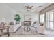 Cozy living room with comfortable seating, a ceiling fan, and ample natural light at 15731 W Redfield Rd, Surprise, AZ 85379
