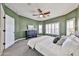 Spacious main bedroom featuring an area rug, ceiling fan, and plantation shutters at 15731 W Redfield Rd, Surprise, AZ 85379