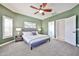 Main bedroom suite featuring an area rug, ceiling fan, and ensuite bathroom at 15731 W Redfield Rd, Surprise, AZ 85379