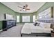 Spacious main bedroom with an area rug, a ceiling fan, and large windows at 15731 W Redfield Rd, Surprise, AZ 85379