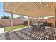 Spacious backyard patio area includes artificial turf, a built-in bbq and pergola at 15731 W Redfield Rd, Surprise, AZ 85379