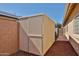 Durable storage shed with neutral siding and a secure gate at 15731 W Redfield Rd, Surprise, AZ 85379