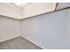 This carpeted walk-in closet has lots of space and wood shelving at 15731 W Redfield Rd, Surprise, AZ 85379
