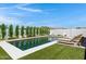 Relaxing backyard with a refreshing pool, comfortable chaise lounges, and vibrant greenery, providing a serene escape at 17084 N Palo Pino St, Maricopa, AZ 85138
