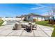 Inviting backyard with a modern pool, comfortable lounge chairs, and a serene patio area with seating at 17084 N Palo Pino St, Maricopa, AZ 85138