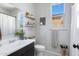 Bright bathroom with white walls, a window, and modern fixtures, complemented by a dark wood vanity at 17084 N Palo Pino St, Maricopa, AZ 85138