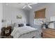Cozy bedroom with a white metal bed frame, wood floors, and soft lighting, creating a comfortable space at 17084 N Palo Pino St, Maricopa, AZ 85138