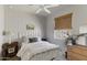 Bedroom featuring a ceiling fan, a bed, a window with blinds, and a dresser at 17084 N Palo Pino St, Maricopa, AZ 85138