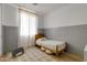 A cozy bedroom with wood floors, wainscoting, and a natural wood bedframe at 17084 N Palo Pino St, Maricopa, AZ 85138
