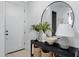 Stylish entryway featuring a decorative table, mirror, and a view of the front door at 17084 N Palo Pino St, Maricopa, AZ 85138