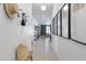 Bright hallway with decorative wall art, coat hooks, and a view into the living spaces at 17084 N Palo Pino St, Maricopa, AZ 85138