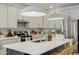 Well-equipped kitchen with an island featuring pendant lighting and modern appliances at 17084 N Palo Pino St, Maricopa, AZ 85138
