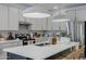 Contemporary kitchen featuring a large island, modern lighting, and stainless steel appliances at 17084 N Palo Pino St, Maricopa, AZ 85138