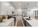 Bright kitchen features an island with a sink, stainless steel appliances, and white cabinets with gold hardware at 17084 N Palo Pino St, Maricopa, AZ 85138