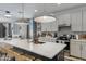 Stylish kitchen boasting a large island, modern appliances, and pendant lighting fixtures at 17084 N Palo Pino St, Maricopa, AZ 85138