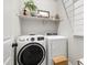 This laundry room features new appliances and a storage shelf at 17084 N Palo Pino St, Maricopa, AZ 85138