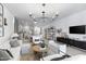 Spacious open-plan living room flowing into modern kitchen with an abundance of natural light at 17084 N Palo Pino St, Maricopa, AZ 85138