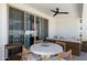 This covered patio features comfortable seating, a ceiling fan, and a round dining table at 17084 N Palo Pino St, Maricopa, AZ 85138