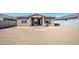 The backyard features a patio space and is enclosed by a block wall fence offering privacy at 17803 W Elm St, Goodyear, AZ 85395