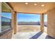 Covered patio overlooks the large backyard, with block wall fence, offering an outdoor living space at 17803 W Elm St, Goodyear, AZ 85395