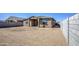 Backyard features a blank slate with block wall fence, waiting to be transformed into a dream outdoor space at 17803 W Elm St, Goodyear, AZ 85395