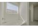 Bathroom featuring a soaking tub with window and a glass-enclosed shower at 17803 W Elm St, Goodyear, AZ 85395