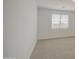 Bedroom featuring plush carpet, neutral paint and a sunlit window at 17803 W Elm St, Goodyear, AZ 85395