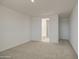 Spacious bedroom with neutral carpet, paint, and access to bathroom at 17803 W Elm St, Goodyear, AZ 85395