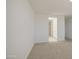 Comfortable bedroom with carpet flooring and a bathroom entrance at 17803 W Elm St, Goodyear, AZ 85395