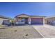Charming single-story home featuring a desert landscape, neutral color palette, and a two-car garage at 17803 W Elm St, Goodyear, AZ 85395
