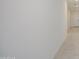 Clean hallway with light tile flooring leading to a door, creating a bright and spacious feel at 17803 W Elm St, Goodyear, AZ 85395