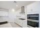 Stylish kitchen boasts white cabinets, a subway tile backsplash, and stainless appliances at 17803 W Elm St, Goodyear, AZ 85395