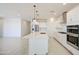 Gorgeous eat-in kitchen featuring an island, stainless appliances, and pendant lighting at 17803 W Elm St, Goodyear, AZ 85395