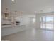 Modern kitchen with white cabinetry, stainless steel appliances, a spacious island, and tile floors at 17803 W Elm St, Goodyear, AZ 85395