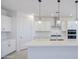 Modern kitchen with a large island, pendant lights, and stainless steel appliances at 17803 W Elm St, Goodyear, AZ 85395