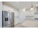 Beautiful kitchen with stainless steel refrigerator and modern white cabinets at 17803 W Elm St, Goodyear, AZ 85395