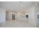 Bright, open kitchen with white cabinetry, stainless steel appliances, and a spacious island, ideal for cooking at 17803 W Elm St, Goodyear, AZ 85395