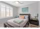 Cozy bedroom with a large window, ceiling fan, and comfy bed with colorful pillows at 1803 E Palm Beach Dr, Chandler, AZ 85249