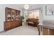 Dining room with a large china cabinet, piano, and bay window offering natural light and ample space at 1803 E Palm Beach Dr, Chandler, AZ 85249
