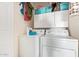 Functional laundry room with white washer and dryer, cabinets for storage and hanging clothes at 1803 E Palm Beach Dr, Chandler, AZ 85249