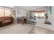 Living room features a large bay window, a piano, and a comfortable seating area with patio access at 1803 E Palm Beach Dr, Chandler, AZ 85249