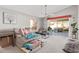 Cozy living room with bright, neutral walls, access to patio, modern ceiling fan, and comfortable furnishings at 1803 E Palm Beach Dr, Chandler, AZ 85249