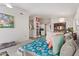 Bright living room with light gray walls and carpet, providing a clear view into the kitchen at 1803 E Palm Beach Dr, Chandler, AZ 85249