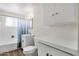 This bathroom features a modern vanity, commode and bathtub with a blue curtain at 1944 W Osborn Rd, Phoenix, AZ 85015