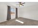 Bedroom featuring neutral carpet, white walls, a ceiling fan, and a large window at 1944 W Osborn Rd, Phoenix, AZ 85015