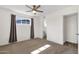 Bedroom features a ceiling fan, neutral carpet and a view into an adjoining bathroom at 1944 W Osborn Rd, Phoenix, AZ 85015