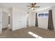 Bedroom featuring neutral carpet, a ceiling fan, closet doors and an attached bathroom at 1944 W Osborn Rd, Phoenix, AZ 85015