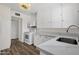 White cabinets and white appliances in kitchen with wood-look floors at 1944 W Osborn Rd, Phoenix, AZ 85015